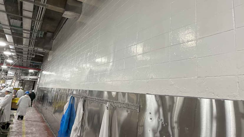 Food processing plant with bright white polyurea coating on walls and ceiling showing clean, hygienic environment